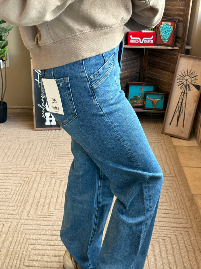 Blue wide-leg jeans close-up of slanted slash pocket and relaxed waistband