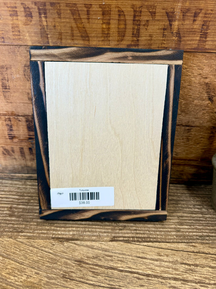 Wood-framed turquoise arrowhead art back panel with barcode label