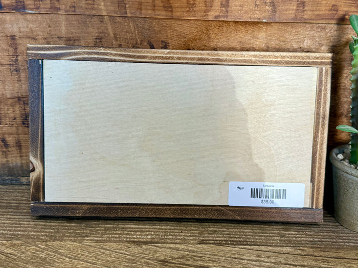 Back of longhorn wood framed art with barcode label on white backing