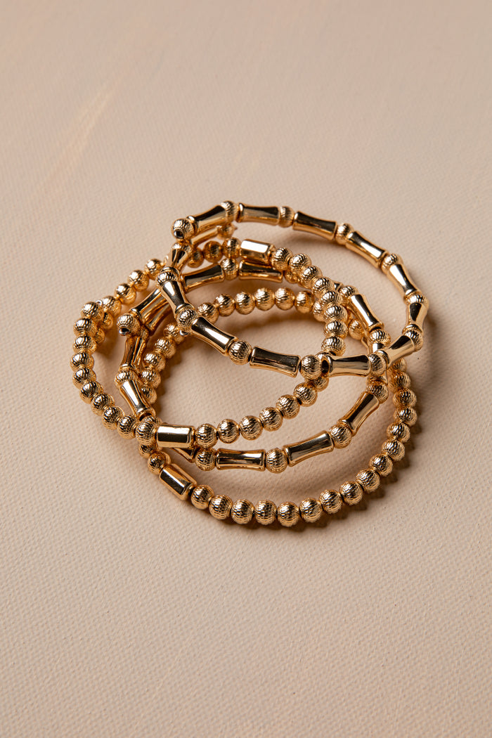 Gold bracelet on a beige background