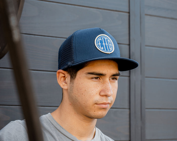 man wearing - blue suavecito hat with white embroidered text and blue background "cito" in round shape