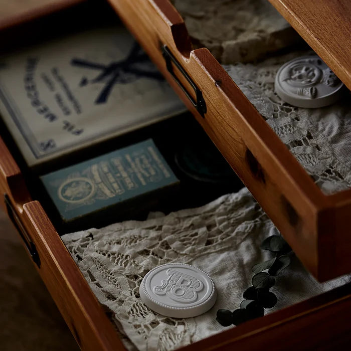 Vintage wooden drawer box styled with lace fabric, botanical accents, and decorative aroma ornaments, creating a rustic antique home fragrance display.