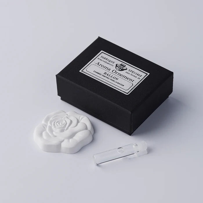 Rose-shaped aroma ornament set with a black vintage-style gift box and small fragrance vial, displayed on a clean white background in a minimalist product presentation.