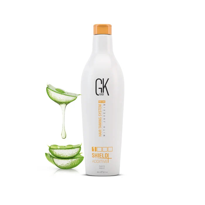 GK Hair Shield Additive+ 650 ml white bottle with an orange cap, beside aloe vera leaves and dripping gel