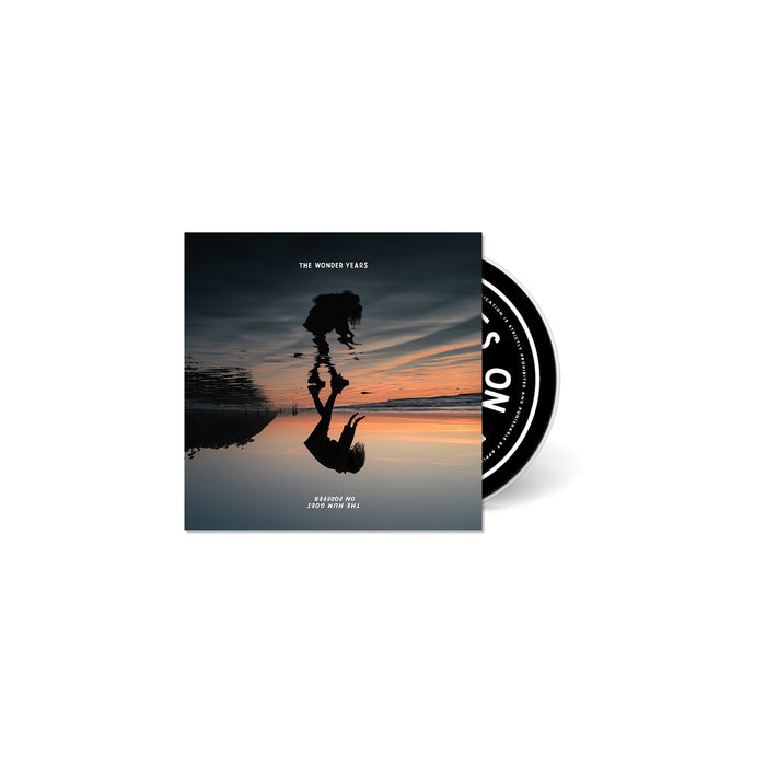 The CD cover for The Wonder Years shows a person with a guitar reflected upside down on wet sand at sunset, the album partly out of its case. Text: THE WONDER YEARS and BURSTING OUT FROM YOUR SOUL. Brand: The Wonder Years.