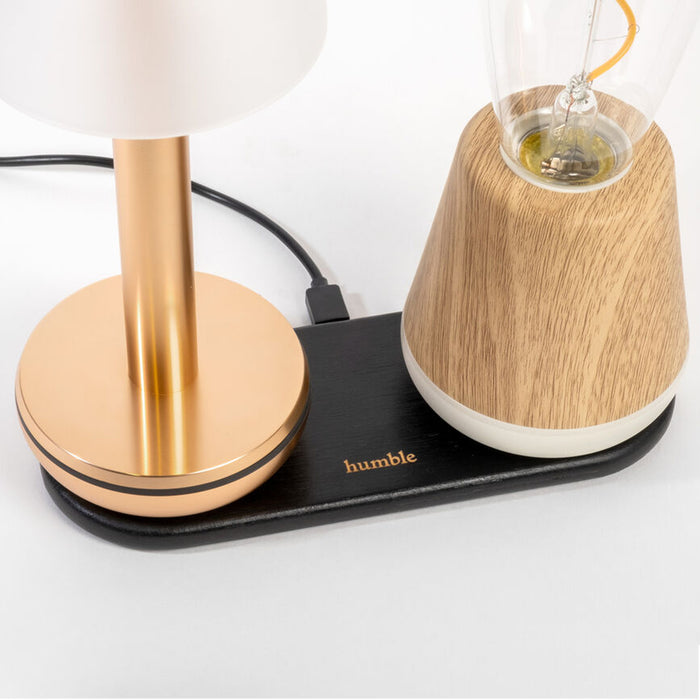 Table lamp with wooden base and white shade on a white background