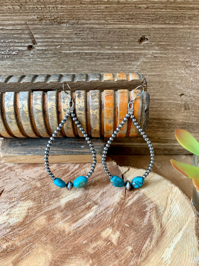 Turquoise bead and silver beaded hoop earrings with dangling oval accents