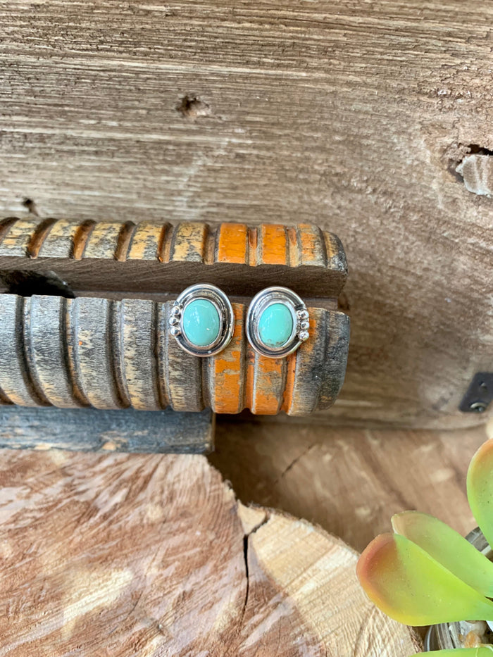 Sterling silver turquoise stud earrings with round turquoise cabochons, ornate bezel
