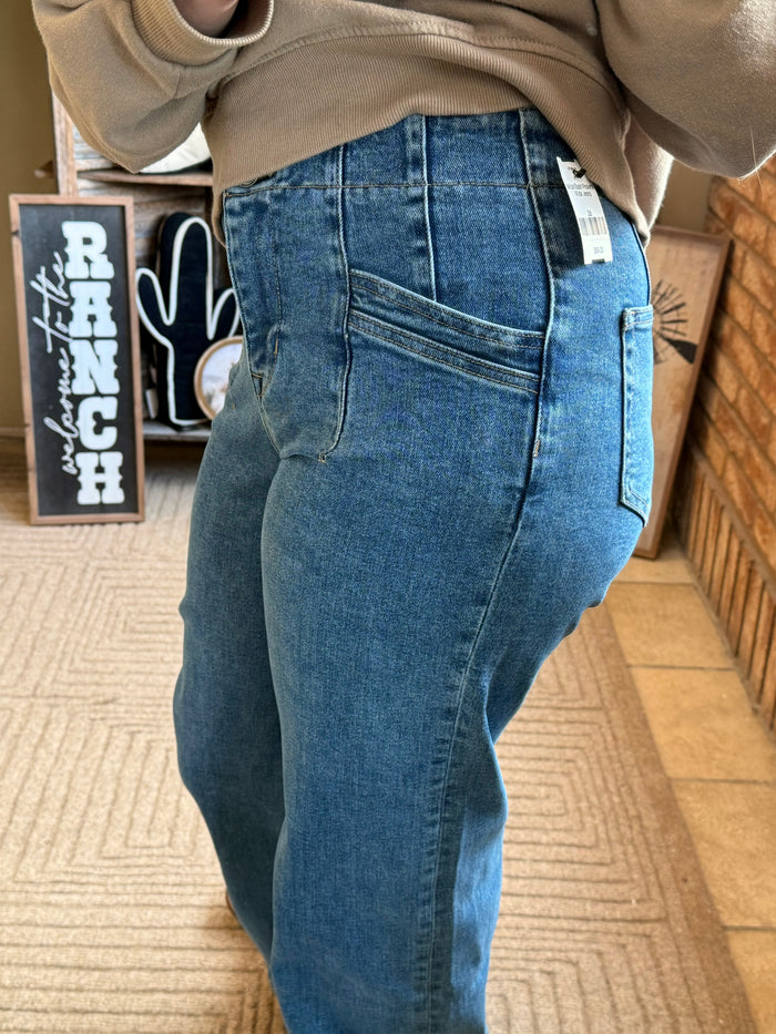 Blue wide-leg denim jeans with stitched panel seams and slash pockets, mid-rise