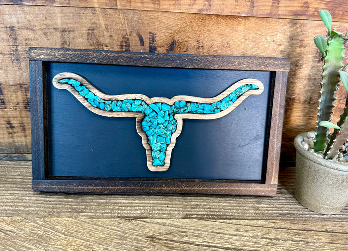 Wood framed wall art with turquoise longhorn silhouette on blue backing.