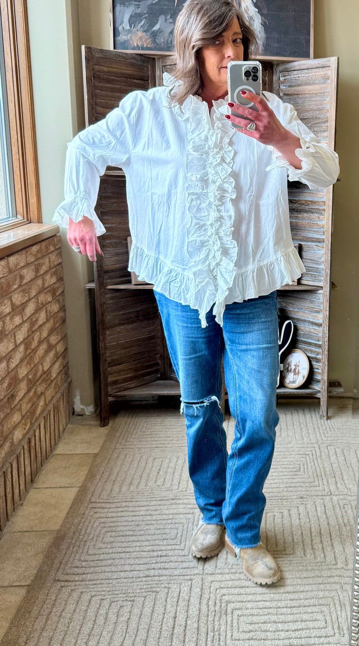 White ruffle cotton shirt with long sleeves and layered front ruffles, side view