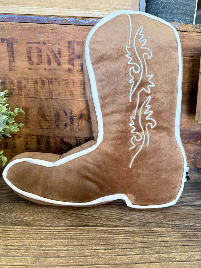 Tan cowboy boot-shaped pillow with white piping and stitched boot-stand motif