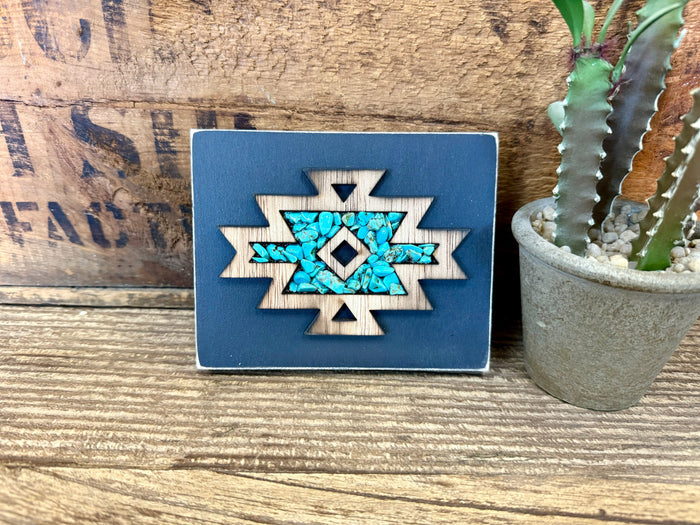Turquoise Aztec wood wall art with blue square backing and carved starburst mosaic center