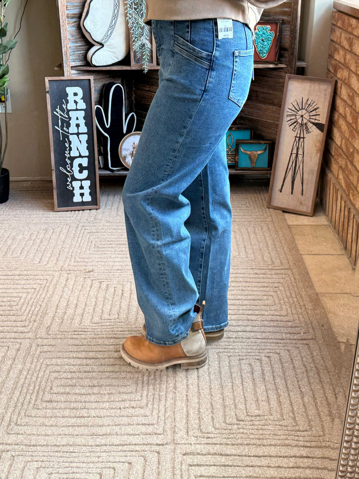 Wide-leg blue denim jeans with slanted slash pockets and relaxed ankle hem