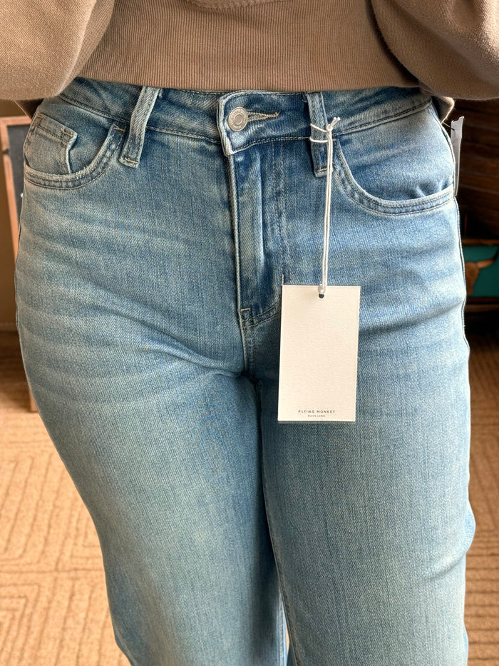 Flying Monkey flare jeans close-up: light blue denim front pockets and waistband