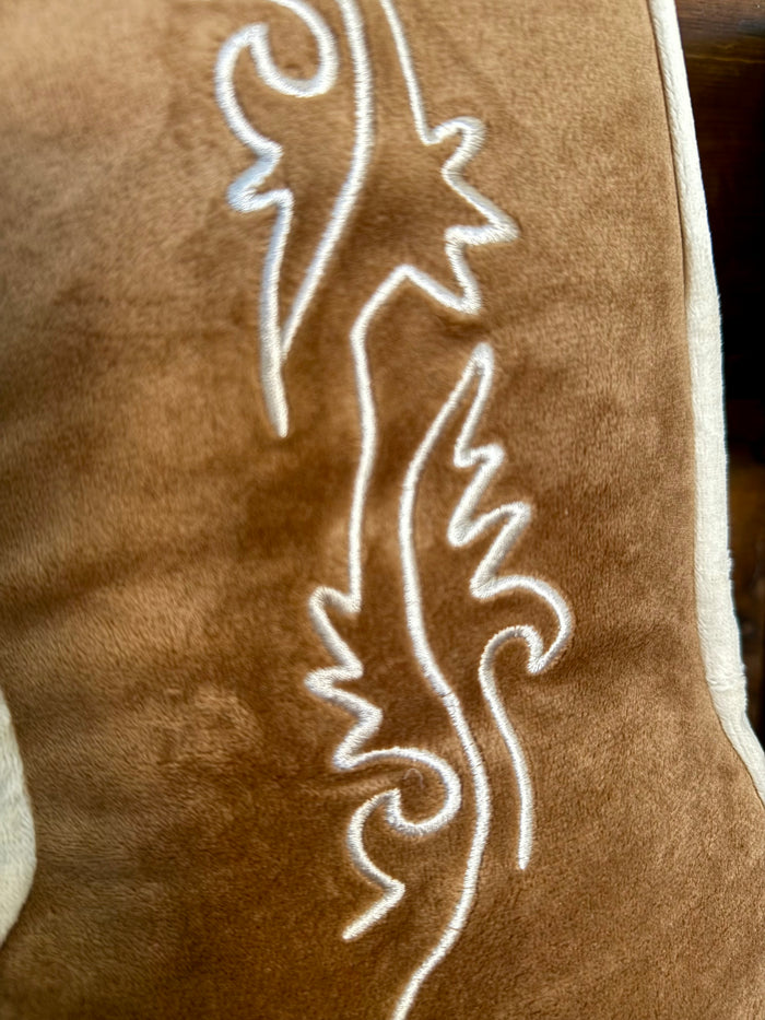 Tan cowboy boot pillow close-up of embroidered line art with white trim
