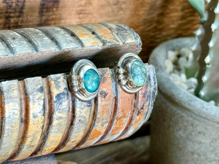 Sterling silver turquoise stud earrings with textured silver settings and oval turquoise stones