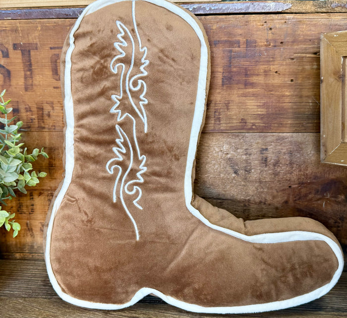 Tan cowboy boot pillow with white trim and embroidered line-art design