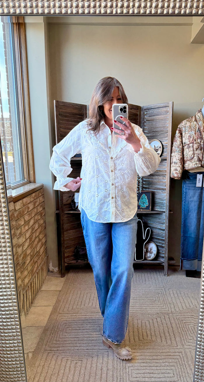 Ivory ruffle button-up shirt with long sleeves and eyelet embroidered front