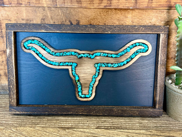Turquoise longhorn wall art with blue textured background in wood frame