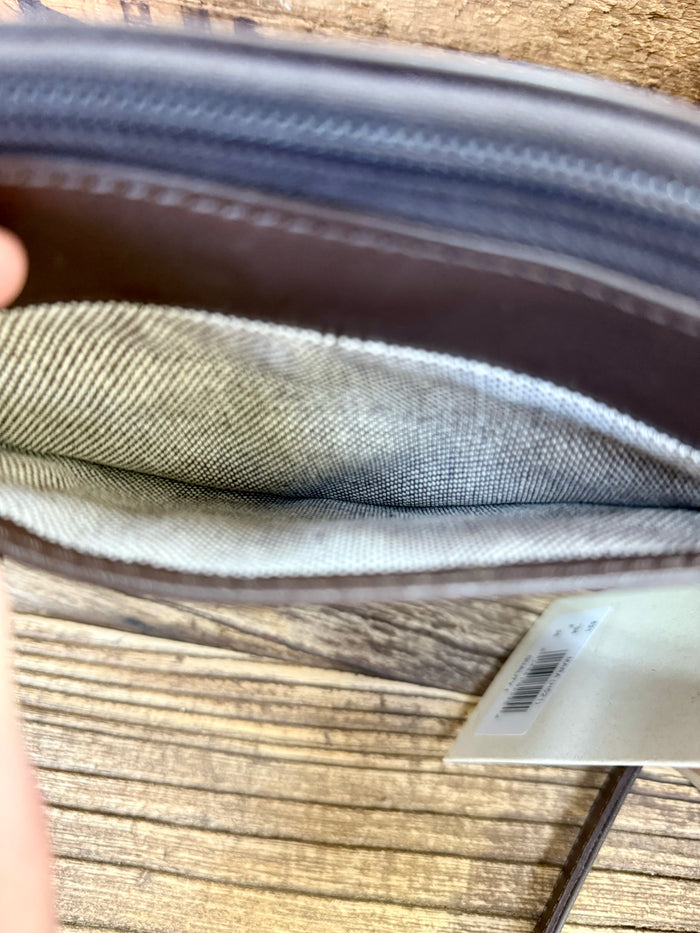 Beige fabric lining inside a brown leather purse with zip closure edge