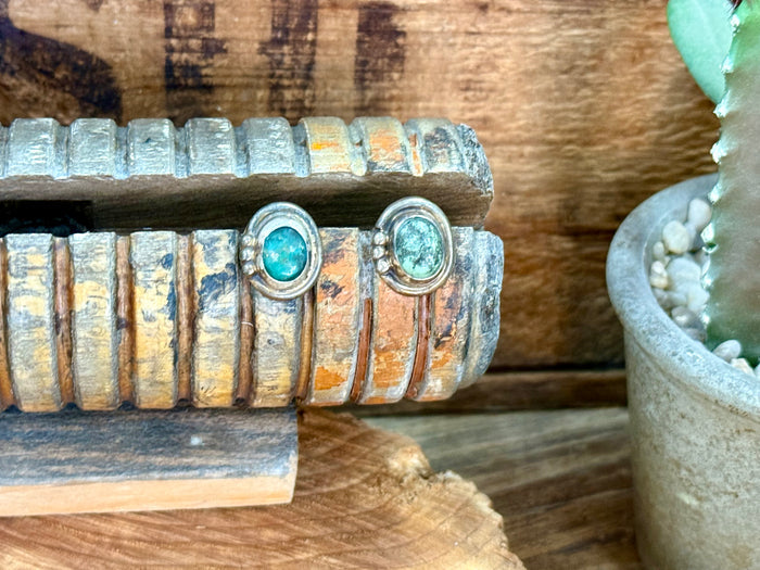 Sterling silver turquoise stud earrings with small round turquoise cabochons and scalloped trim
