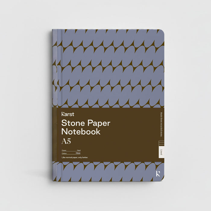Stone Paper Notebook with blue and brown design on a light gray background