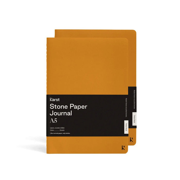Karst A5 Stone Paper Journal twin pack in turmeric yellow with soft covers and black branded belly band, displayed on a light gray background.
