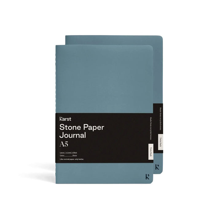 Karst A5 Stone Paper Journal twin pack in glacier blue with soft covers and black branded belly band, displayed on a light gray background.