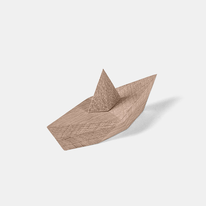 Wooden toy boat on a white background