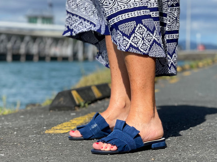 Quality European women's slide sandal. Soft leather with frill trim. In blue