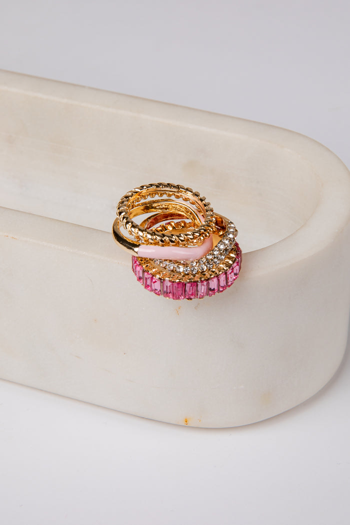 Gold and pink ring on a white surface