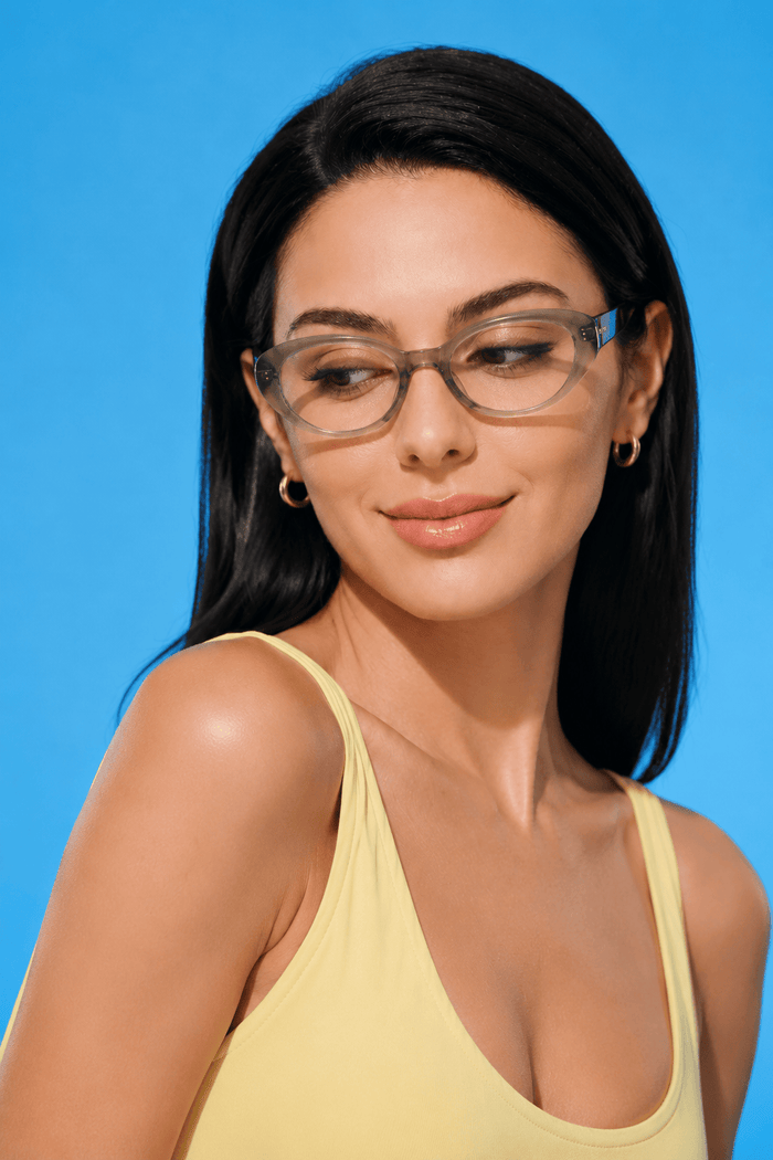 EyeCandys Bardot Cat Eye Matcha clear frame glasses model shot featuring transparent matcha green cat-eye frames with non-prescription clear lenses, trendy women's fashion eyewear for everyday wear, office style, blue light fashion frames, and modern minimalist looks.