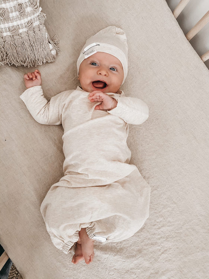 Soft and stretchy Heather cream  beanie for kids, made from eco-friendly fabric. Ethically crafted in Canada, featuring a fold-over brim and minimalist design