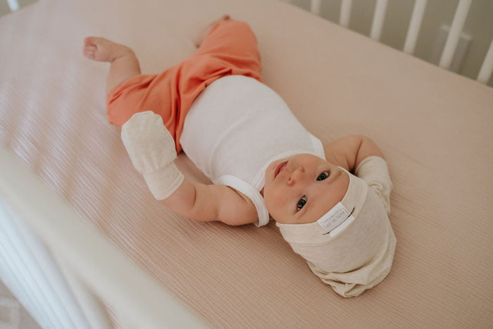 Soft and stretchy Heather cream  beanie for kids, made from eco-friendly fabric. Ethically crafted in Canada, featuring a fold-over brim and minimalist design