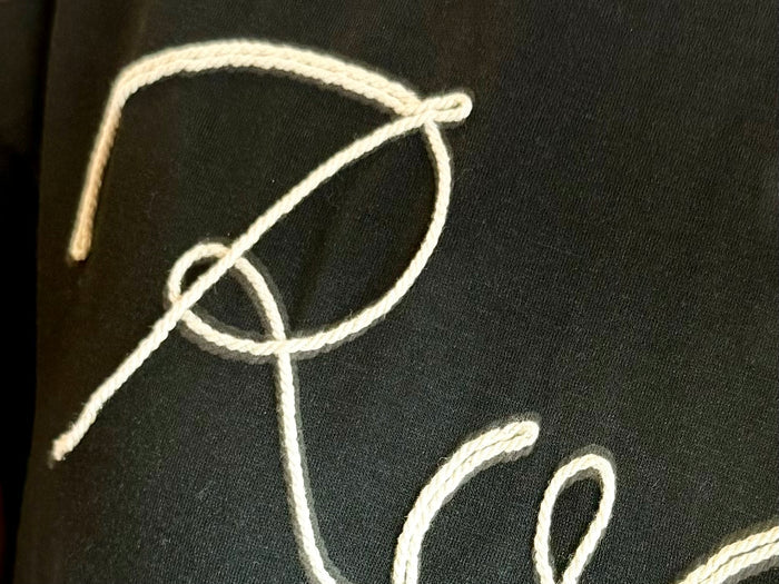 Black T-shirt with white rodeo rope and lasso graphic detail