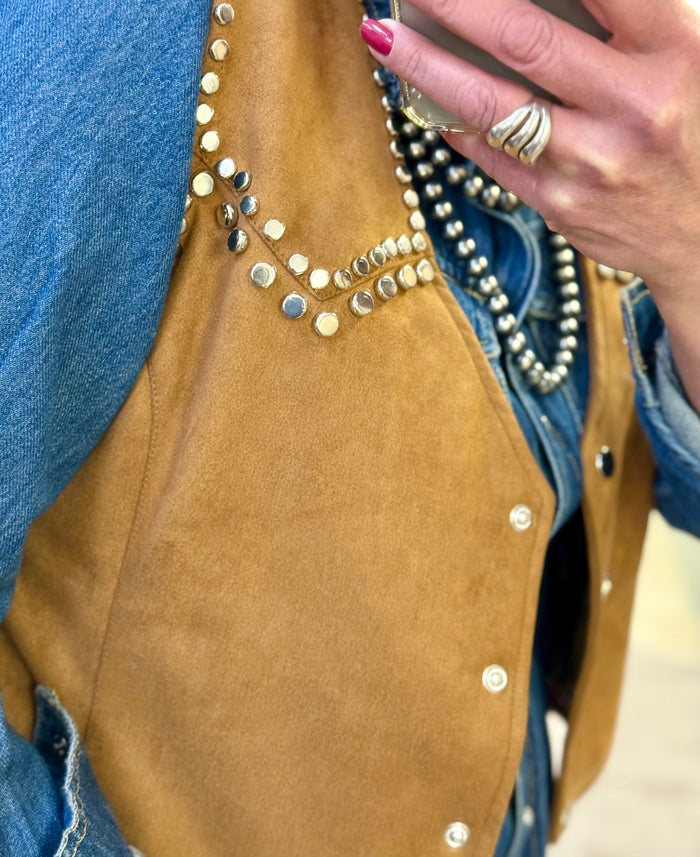 Camel-brown suede vest panel with rhinestone-like studs and snap buttons
