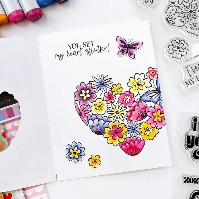 Catherine Pooler - Stamp & Die Set - Hearts Aflutter. Set someone's heart aflutter with this beautiful stamp set and coordinating dies! The Hearts Aflutter Stamps features a large, line-art heart made of flowers and a butterfly. Available at Embellish Away located in Bowmanville Ontario Canada Example by brand ambassador.