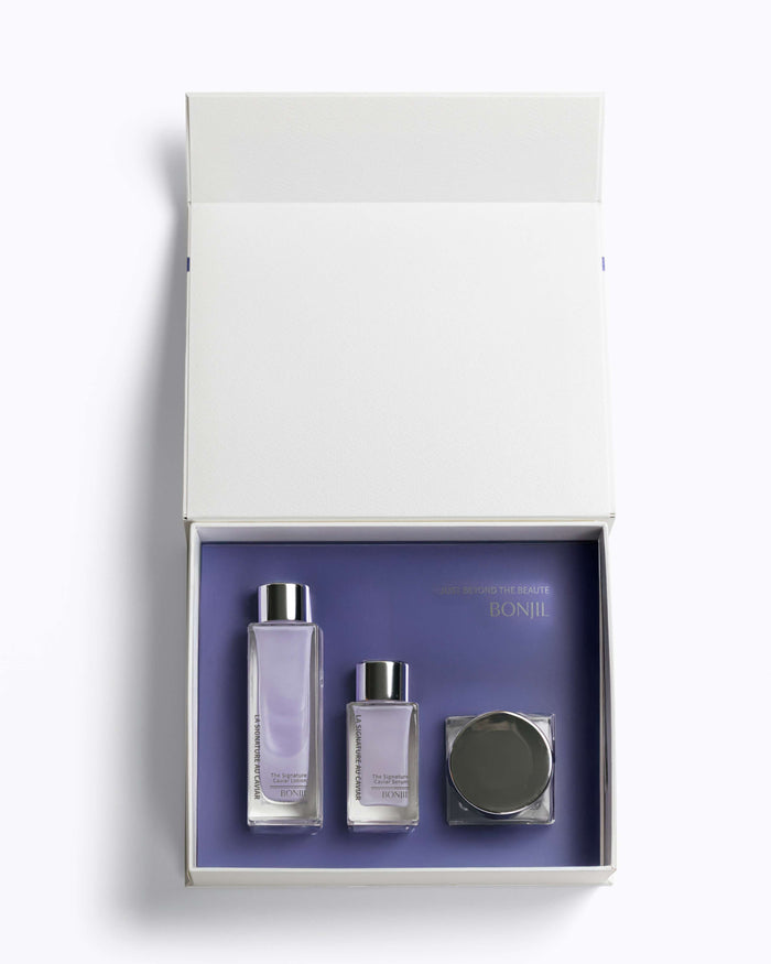 Set of skincare products in a white box with a purple interior