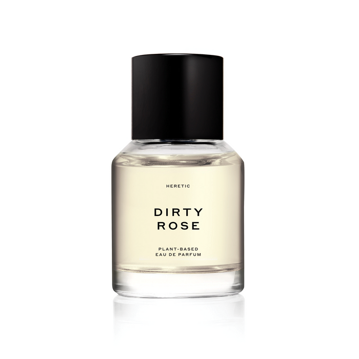 A bottle of 'Dirty Rose' perfume by Heretic with a clear, black cap and label, set against a white background.