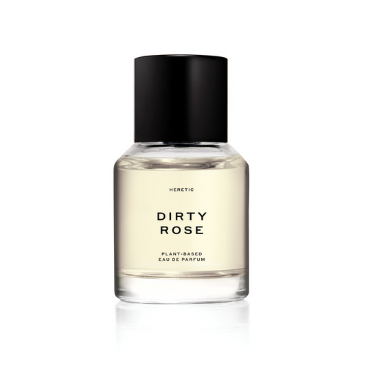 A bottle of 'Dirty Rose' perfume by Heretic with a clear, black cap and label, set against a white background.