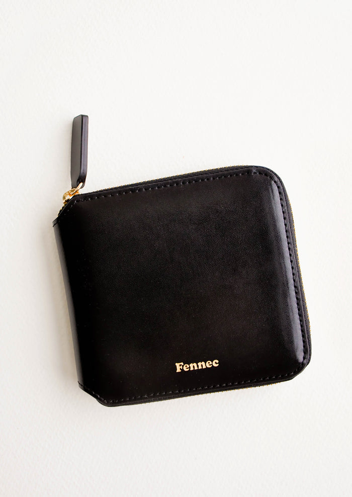 Black leather wallet that zips on three sides, with matching tab pull.