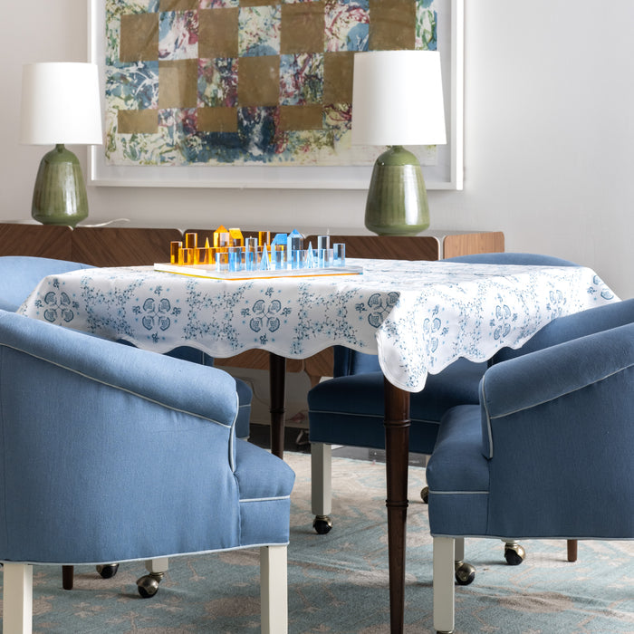 Game table with blue patterned game table topper and acrylic chess set.