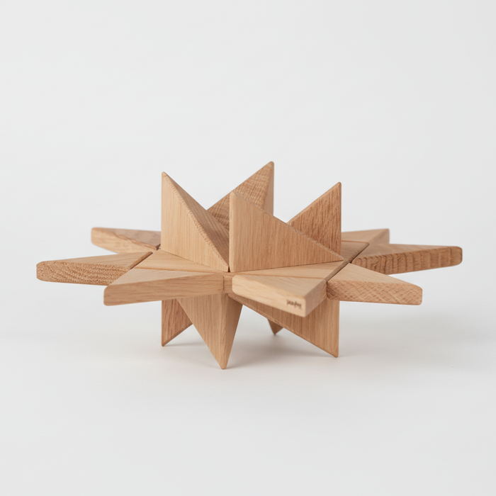Geometric star-shaped wooden object crafted from light oak, formed by intersecting flat planes and pointed facets, highlighting clean lines, natural wood grain, and a smooth matte finish on a plain white background.