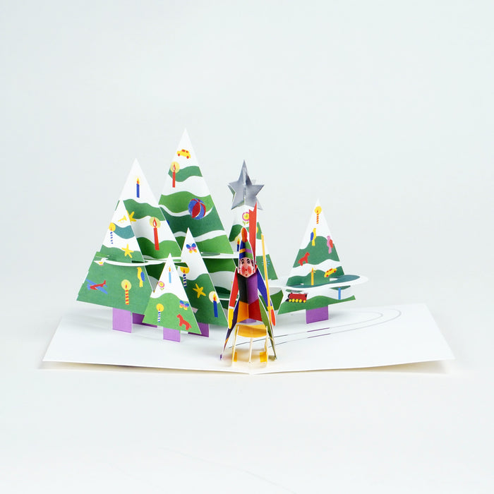 3D pop-up card with Christmas trees and a star on a white background