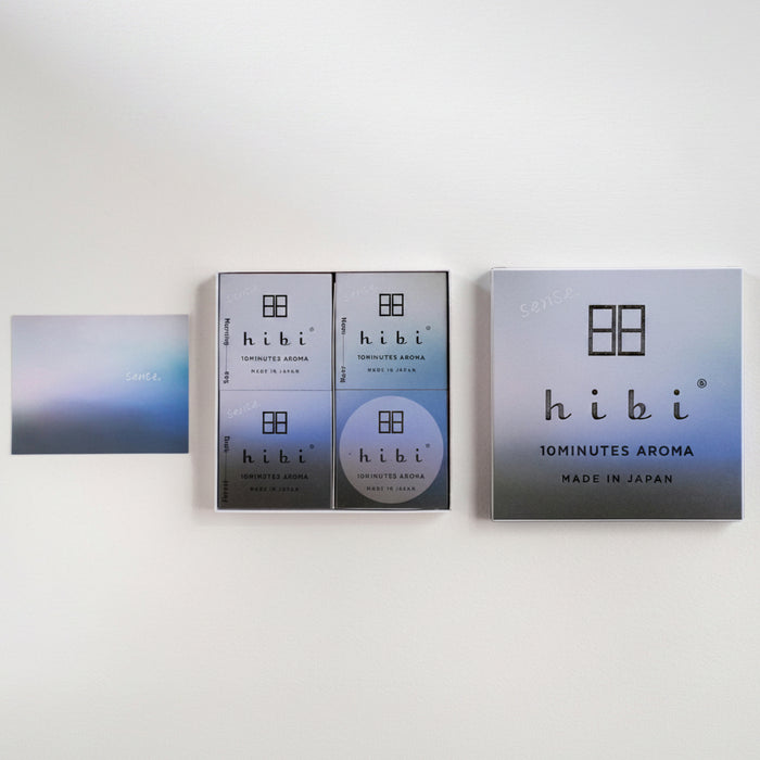 Hibi 10minutes Aroma product packaging set on a clean white background, featuring a square box, two smaller rectangular boxes, a round disc, and a small card.