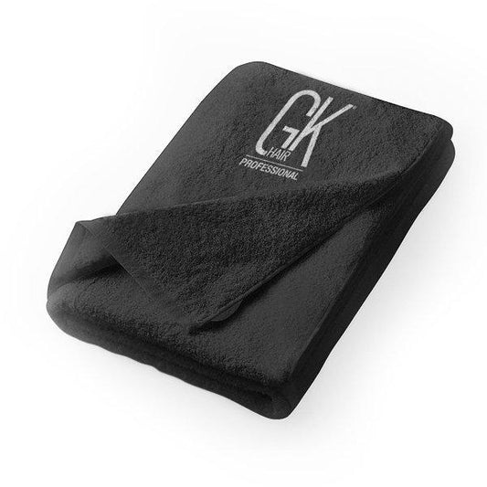 GK Hair Black Towel 70cm folded with the corner turned back, GK Hair Professional logo embroidered in white