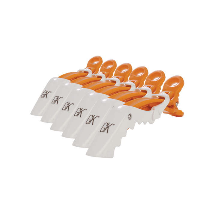 GK Hair Shark Clips, six white and orange sectioning clips fanned in a row with the GK logo on each white paddle, on white
