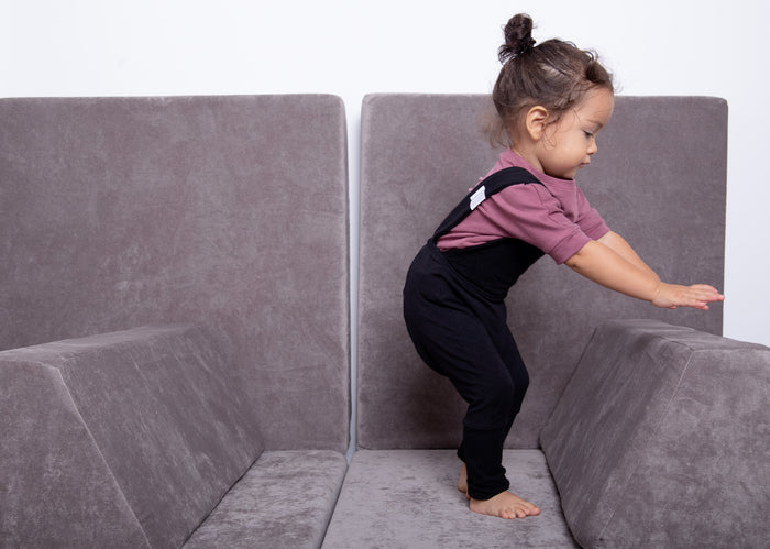 black grow-with-me overalls for toddlers and kids, made from soft, eco-friendly fabric. Adjustable straps and cuffs for a long-lasting fit. Ethically made in Canada.