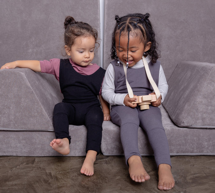 black grow-with-me overalls for toddlers and kids, made from soft, eco-friendly fabric. Adjustable straps and cuffs for a long-lasting fit. Ethically made in Canada.